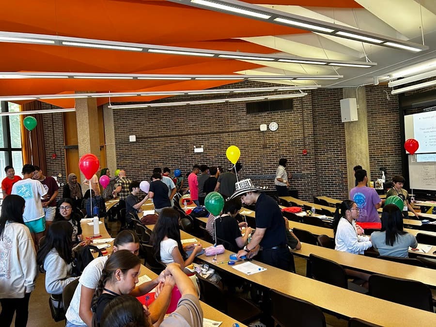 group of educators and students building their balloon project