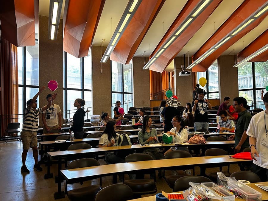group of educators and students building their balloon project