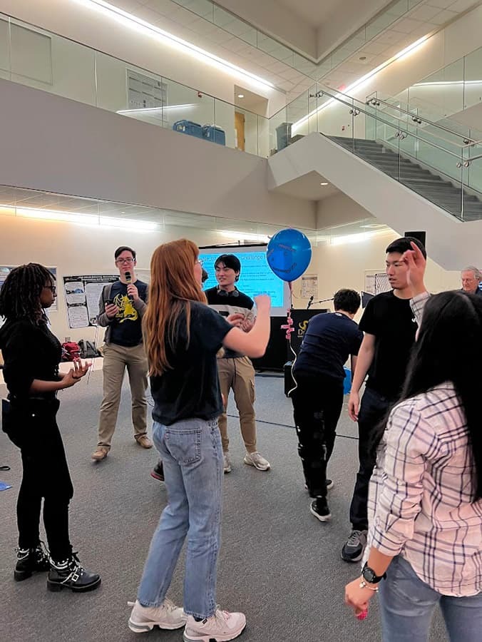 group of educators and students building their balloon project