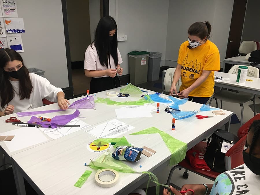 Indoor kite building showing students working