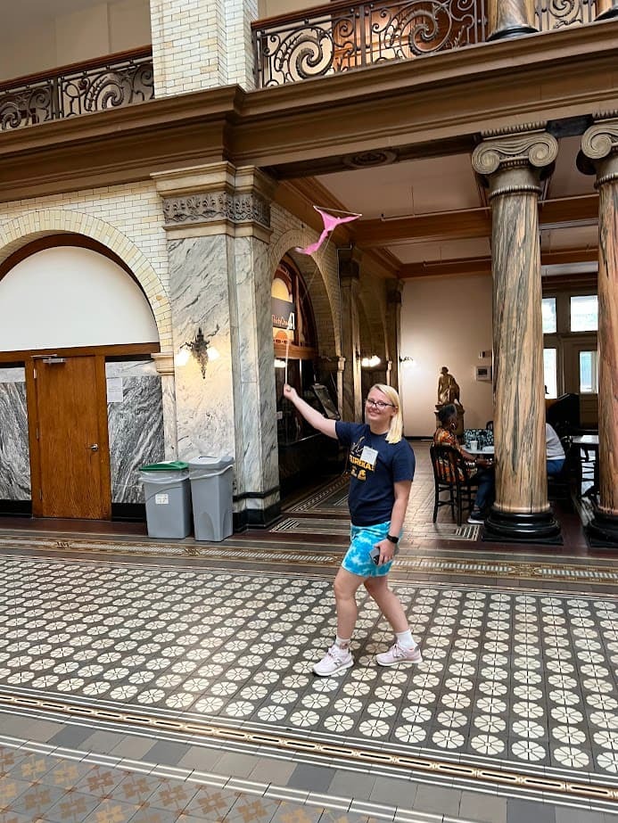 Indoor kite flying showing a student with her kite