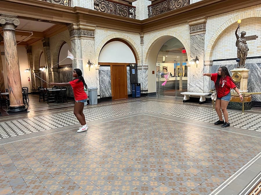 Indoor kite flying showing two students with their kites