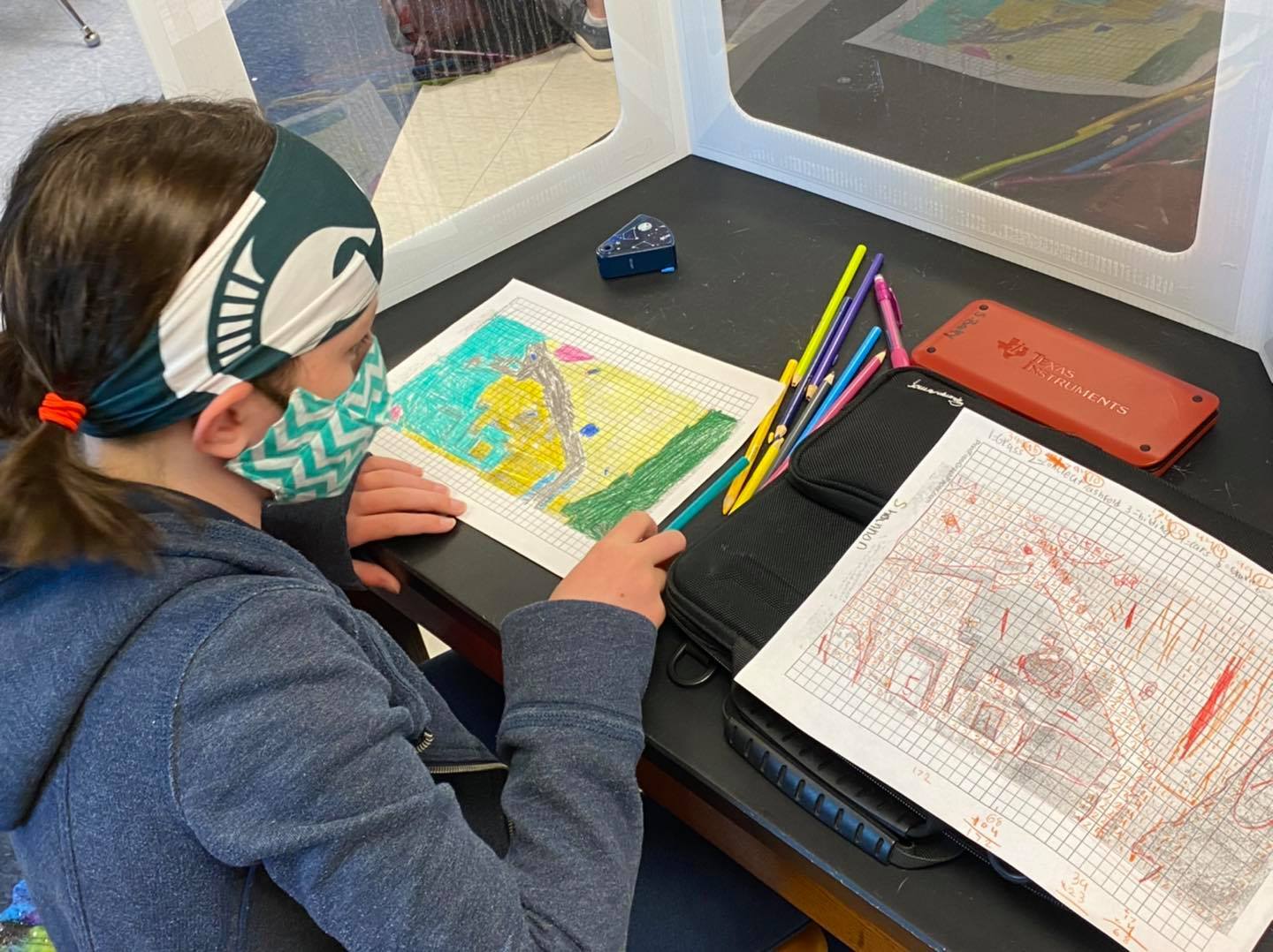 Student working on coloring a topographical map