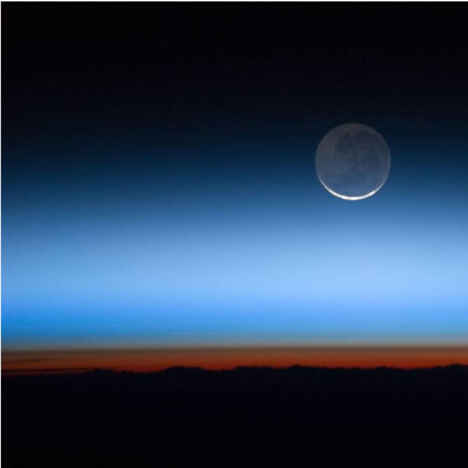 Aerial image of the Earth horizon and the moon in the distance