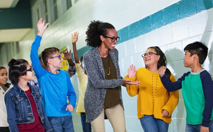 Positive Engagement from Educators with students surrounding a teacher